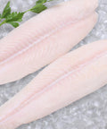 Frozen Pangasius Fish Fillet laid on a bed of ice
